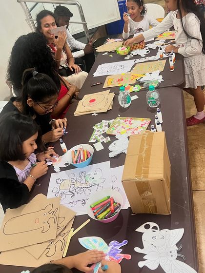 A table full of creativity. Kids and parents are busy making various puppets at a BNI family event. I provide different options to suit all ages and interests.