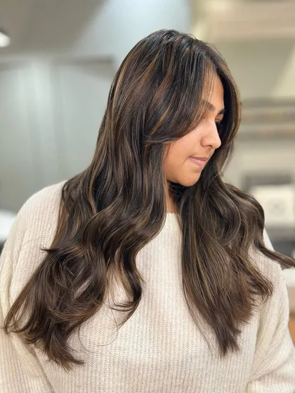 This dimensional brunette balayage adds subtle highlights to create depth and movement without a drastic color change.