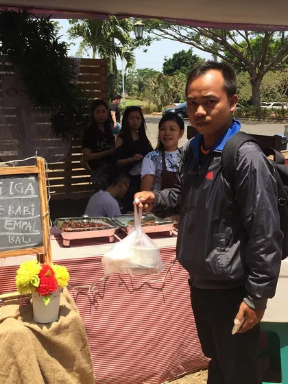 Here's a look at my pop-up stall! Since I run a delivery-only kitchen, I pack every order fresh. This Gojek driver is ready to bring some delicious Indonesian food straight to a customer's home.