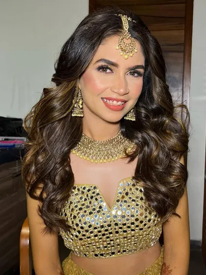 A beautiful portrait of the Sangeet bride. Her soft waves and radiant makeup create a look of effortless glamour.