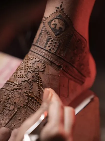 Continuing the application on the same foot design. Here, I am adding delicate lotus motifs and a small elephant figure, which is a symbol of good luck.