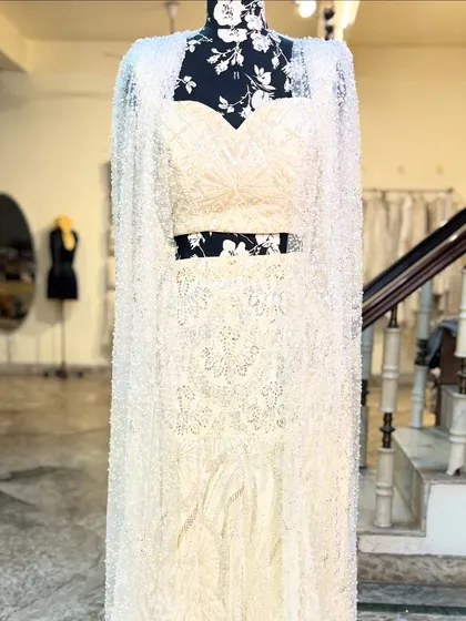 The 'APSARA' lehenga with its matching sparkly cape. This is for the bride who wants a touch of drama.
