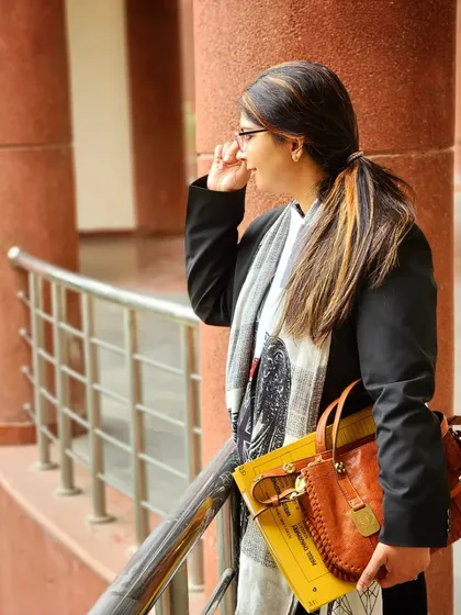 A lawyer's work often involves hours spent in court corridors, preparing for the next hearing. Here is my partner, Parul, between sessions, always focused on the case at hand.