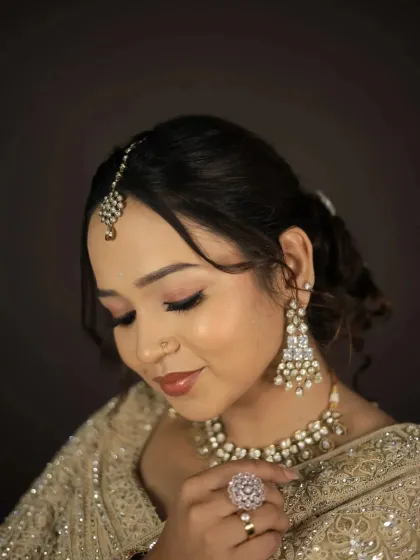 A detailed shot of the pearl and kundan earrings and the large cocktail ring.