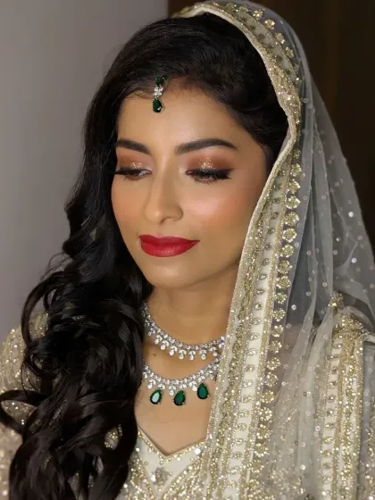 A portrait of my sweet Walima bride, Afrin. The combination of a white and gold outfit with emerald jewellery and red lips is timeless.