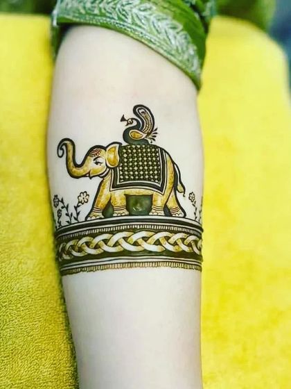 A majestic elephant with a peacock on its back, designed as a beautiful armband.