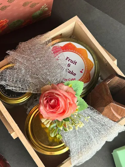 This is one of my custom Diwali hampers, featuring a mix of my handmade fruit and nut cake, dessert jars, and a wooden pen stand. It represents my focus on creating sustainable and thoughtful festive gifts.