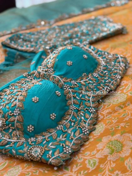 A turquoise blouse with leaf-patterned zardosi work.