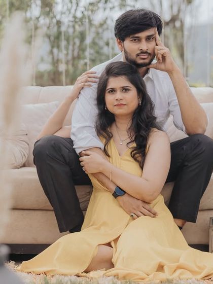 A relaxed and stylish portrait with a vintage feel. The props and the couple's natural pose create a cool, laid-back atmosphere.