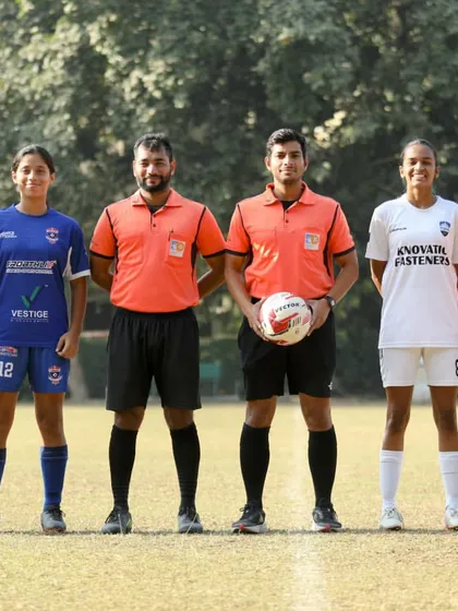 The pre-match lineup with team captains and officials for the game against Warriors FC, showcasing the formal proceedings of the Women's Championship.