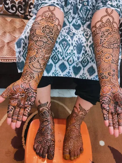 The beautiful and intricate mehndi for bride Kulsum, featuring her groom's name 'Irfan' on her palm.