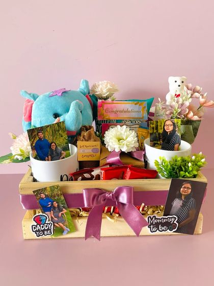 The parents-to-be hamper is personalized with "Mommy to be" and "Daddy to be" stickers and photos, celebrating their new journey together.