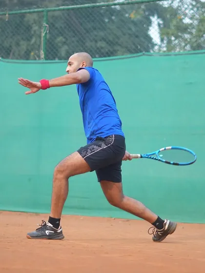 A player demonstrates perfect form during a forehand drill. Our coaching emphasizes progress over perfection, focusing on building solid technical fundamentals.