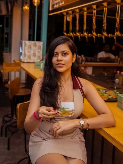 A guest enjoys a quiet moment at the bar, savoring a dessert. Even in the midst of a bustling evening, there are corners in my mansion for personal indulgence and reflection.