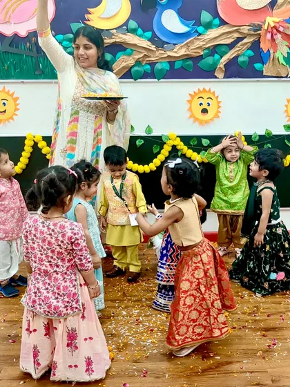 Showering flower petals and joy. The children are having a wonderful time celebrating Diwali with their friends and teachers.