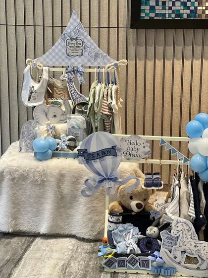 Two of my favorite creations side-by-side. On the left, a 'Teeny Tiny Trendsetter' wardrobe, and on the right, a 'Hello Baby Dhruv' hamper with a rocking horse and teddy bear.