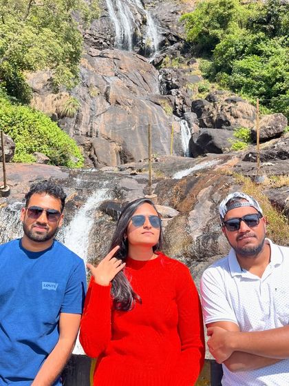 Posing in front of a waterfall in Munnar. Our trips are full of such picture-perfect moments.