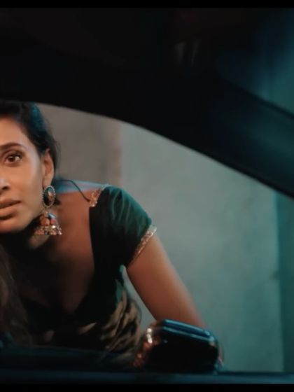 A still from the narrative campaign for Infinix. The styling for this character, with traditional earrings and a concerned expression, helps build a cinematic and emotionally charged story.