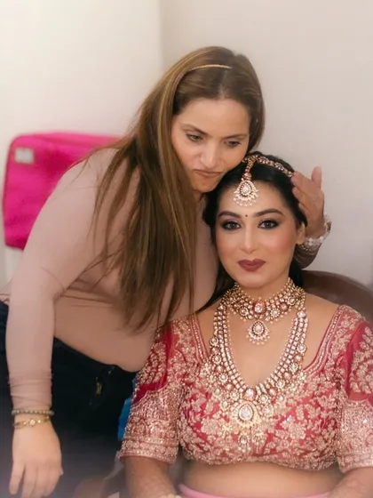 Making final adjustments to the bride's look. My responsibility is to make sure she looks and feels perfect on her big day.