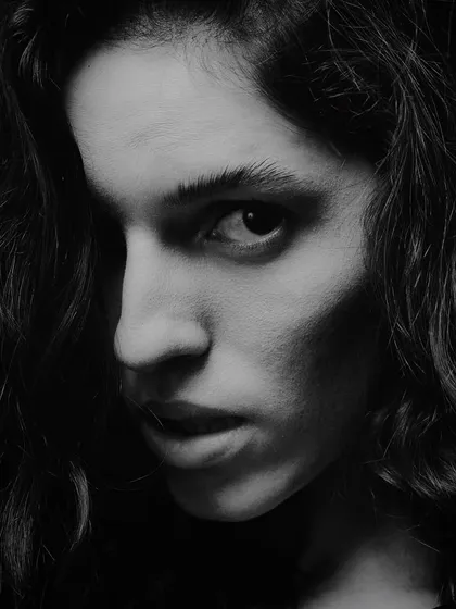 A portrait has to have grit. This high-contrast, black and white shot is all about raw intensity. By using hard light and deep shadows, we carve out the subject's features and create a mood that's direct and unapologetic. This is the kind of powerful portraiture I love to create.