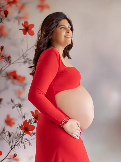 A simple and powerful portrait. The focus is entirely on her pregnancy glow and the beautiful shape of her bump.
