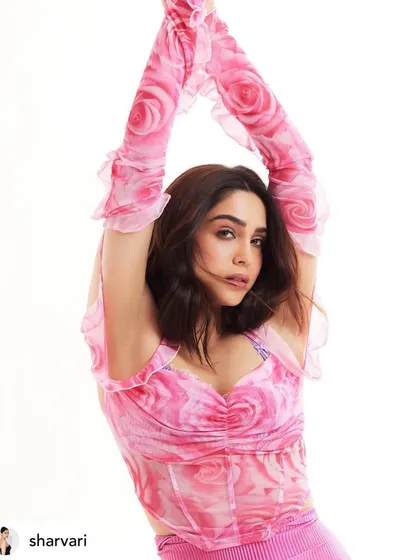 Sharvari Wagh in a playful and feminine pink outfit. The makeup is light and fresh, with a focus on glowing skin and soft pink tones.