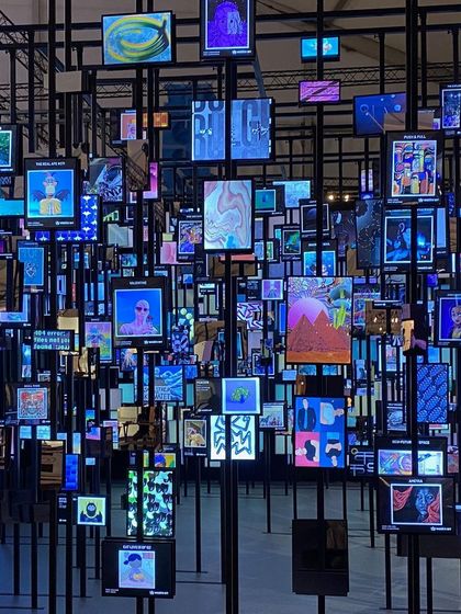 The 'Artify' installation creates a forest of glowing screens, each displaying a unique NFT. The space is a physical manifestation of the metaverse, designed to explore how we consume and value art in today's digital age.