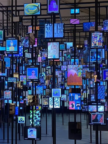 The 'Artify' installation, a metaverse of possibilities. This space, filled with screens displaying NFTs, explores how people consume art in the digital age.