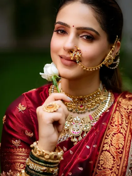A soft and romantic look for a beautiful Navari bride. The makeup is kept minimal and clean, with softly defined eyes and a neutral lip color to let the rich maroon of her saree and the intricate gold jewelry stand out. This is my signature soft glam.