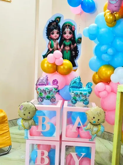 A detailed view of the 'BABY' blocks and balloon arrangements used in the Kanha ji theme, showing the mix of colors and character cutouts.