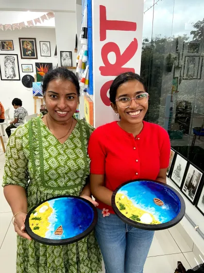 A couple proudly displays their finished resin beach art. It's a fun and creative way to spend time together.