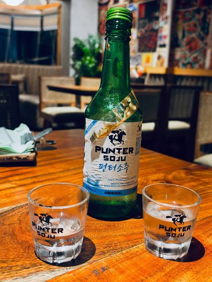 Featuring Plunter Soju, a popular Korean spirit. This type of product placement is perfect for brands looking to reach an audience that enjoys authentic Korean food and drink pairings.