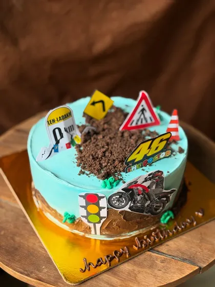 Another view of the bike-themed cake, showing all the different road sign toppers.