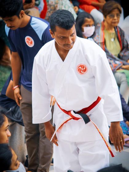 Showing respect is a two-way street. Here, I bow to the students and their families at an event, acknowledging their dedication and trust in our academy.