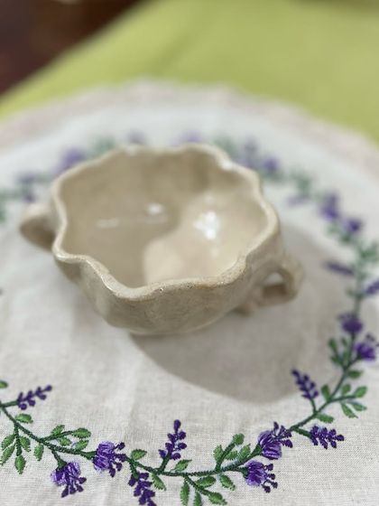 A beautiful example of student work. This is Isobel’s scalloped, two-handled mug, now glazed and ready to be used. The simple, elegant form is just lovely.