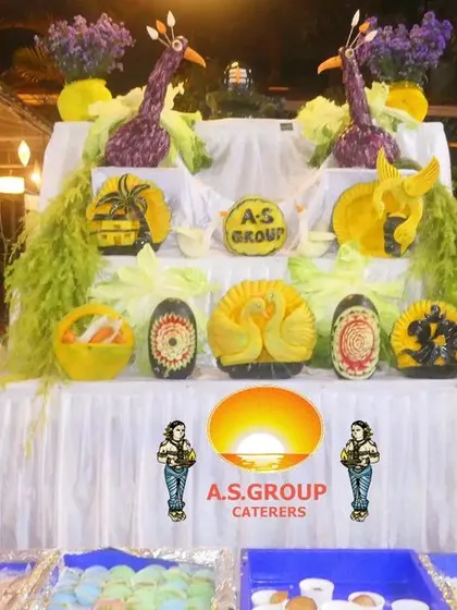 Presentation is an art I take seriously. These intricate fruit and vegetable carvings, shaped like peacocks, add a touch of elegance and surprise to the buffet display at a wedding event.