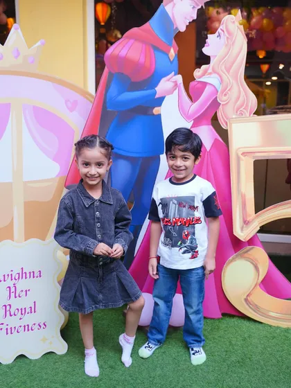 Friends posing by the "Her Royal Fiveness" entrance sign. Our custom signage adds a personal and charming touch to the celebration.