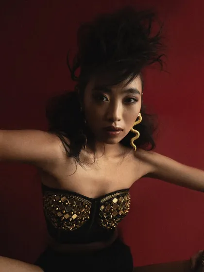 A dynamic, confrontational pose from the 'Ethereal' series. The composition is cropped to create a sense of energy and movement, focusing on the model's expression and the wild texture of her hair.