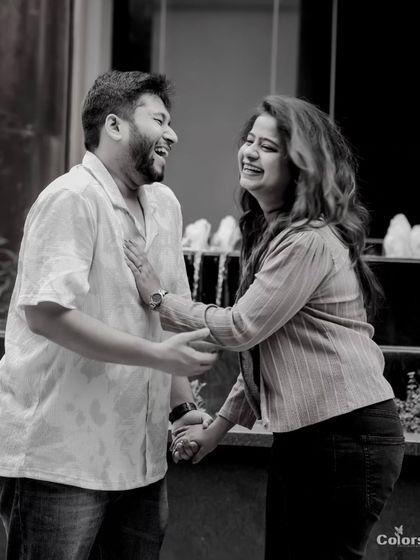 A black and white photo capturing a moment of shared laughter.