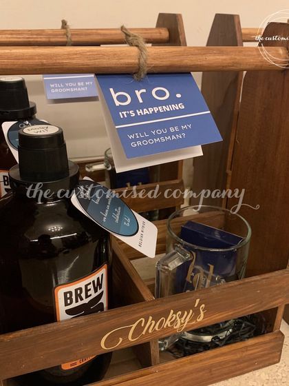 A perfect gift for the beer-loving groomsman. This wooden beer crate comes with a personalized mug, craft beer from Brew Whale, and custom playing cards for a complete gift set.