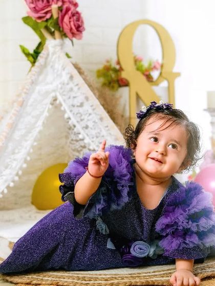 Cuteness alert. This little girl is pointing up, full of wonder and curiosity, in this beautiful bohemian-themed setup.