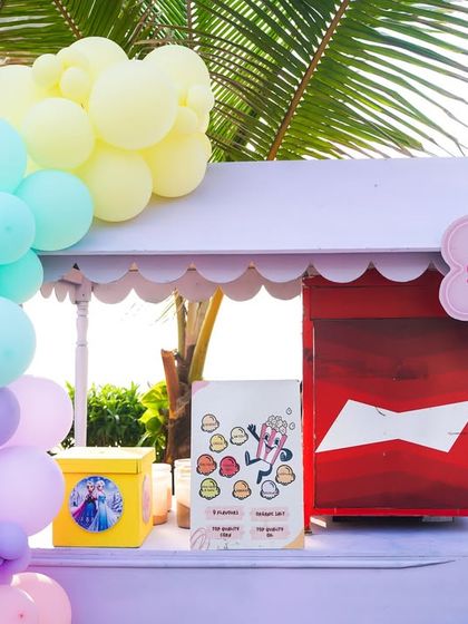 A pastel-colored popcorn cart that perfectly complements the soft, dreamy aesthetic of a Disney Princess party.