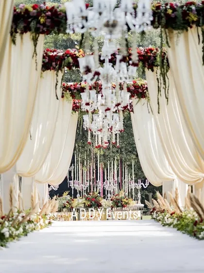 The journey to your forever should be as beautiful as the destination. We design magical aisles like this one, with grand drapery, floral arches, and suspended chandeliers to ensure your entrance is nothing short of spectacular.