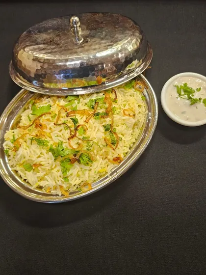 This is my Nawabi style Mutton Sufiyani Biryani, served in a traditional silver handi. It's a rich and aromatic dish made with long-grain rice, tender mutton, and a blend of special spices, perfect for making your celebration feel royal.