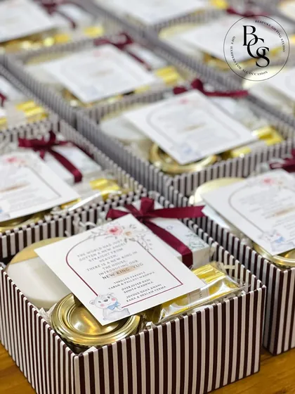 A collection of baby announcement gift boxes, featuring traditional Indian silver items and sweets. This is a wonderful way to blend modern gifting with cultural traditions when welcoming a new baby.