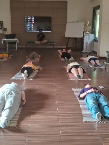 Practitioners rest in Savasana (Corpse Pose) at the end of a class. This essential posture allows the body and mind to integrate the benefits of the practice, promoting deep relaxation.