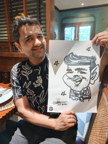 A guest from the Friendship Day event at Mr. Merchant. His caricature captures his happy and friendly personality.