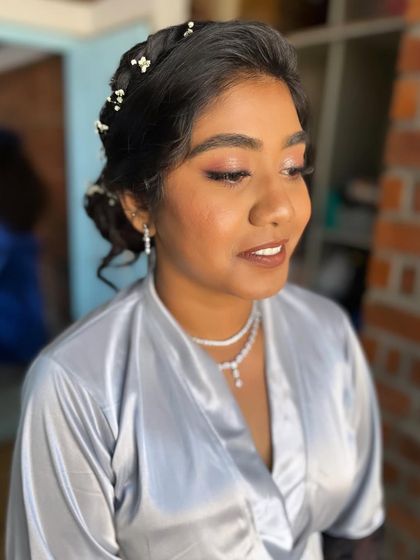 A close-up of Anu's makeup. The peachy tones on her eyes and cheeks give her a warm, healthy glow.