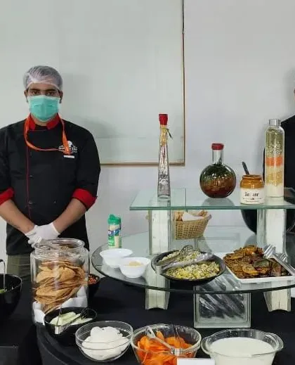 Our professional chefs in uniform, ready to serve at a corporate event. Their expertise and courteous service are a key part of the Brunch N Bite experience.