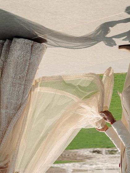 An artistic shot using the reflection of the couple's shadow. This creative portrait is a unique and memorable way to capture their connection, turning a simple walk into a piece of abstract art.